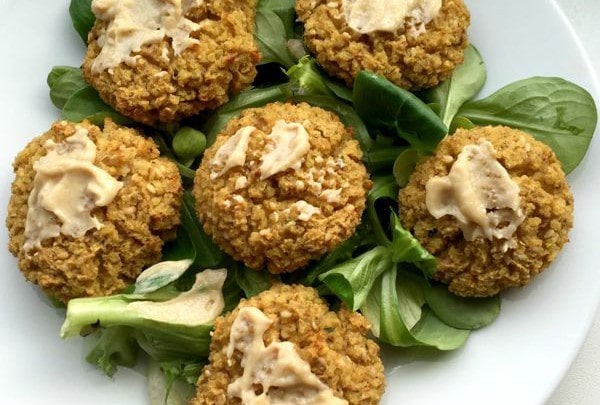 Six low FODMAP falafels on a plate with lettuce