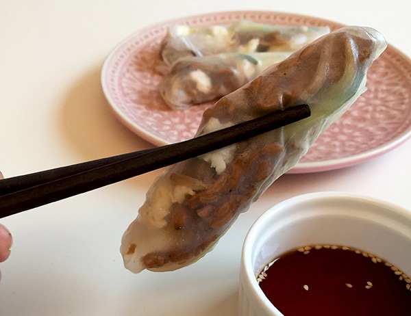 Chopsticks holding a low FODMAP tempeh spring roll