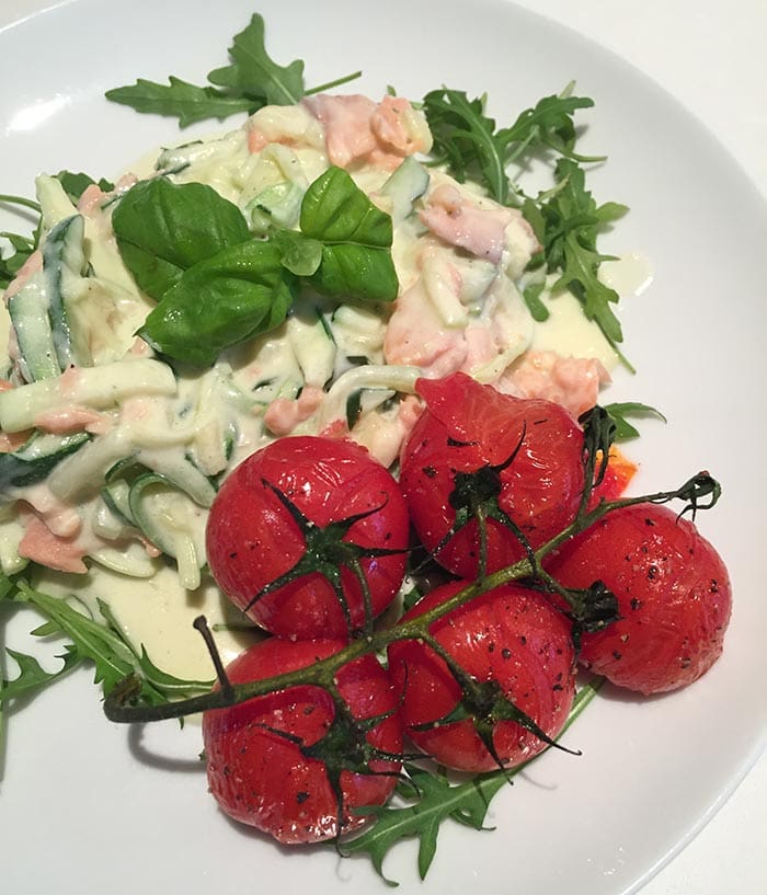 A creamy zucchini pasta with salmon and grilled tomatoes