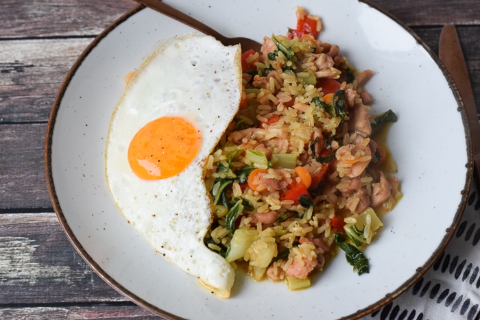 low FODMAP nasi goreng on a plate with a fried egg on top of it