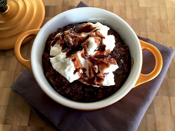 A small pan with low FODMAP chocolate baked oatmeal with yoghurt on top