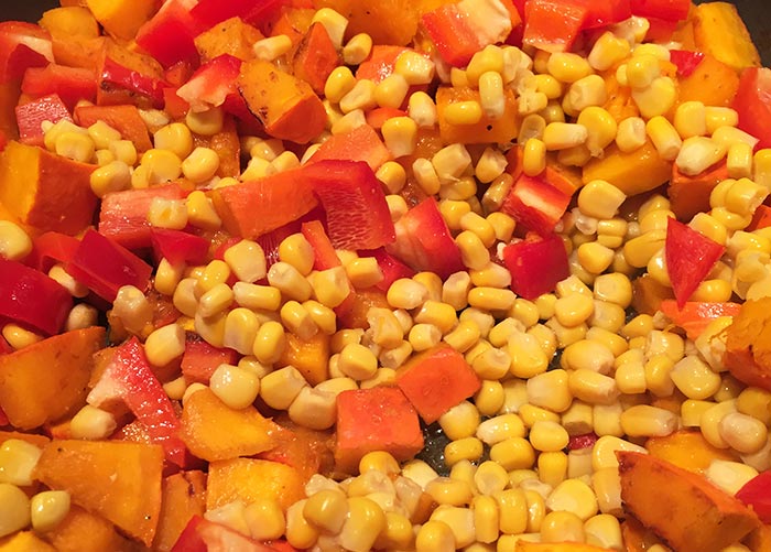 Bell pepper, pumpkin and corn in a pan