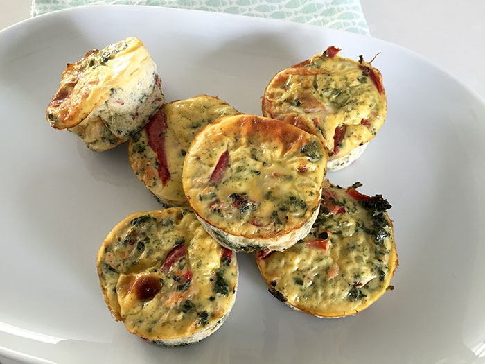 Egg muffins with salmon and spinach on a plate