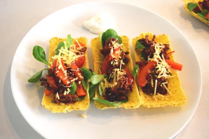 Three low FODMAP taco tubs with filling on a plate