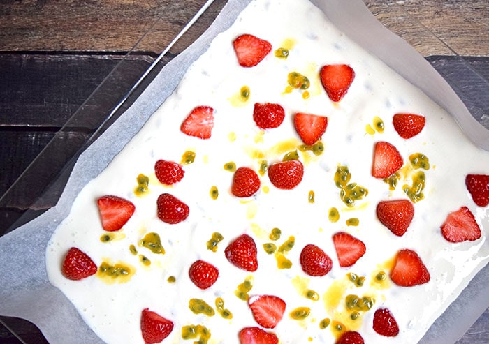 Lactose-free yoghurt with strawberries and passion fruit on a baking sheet