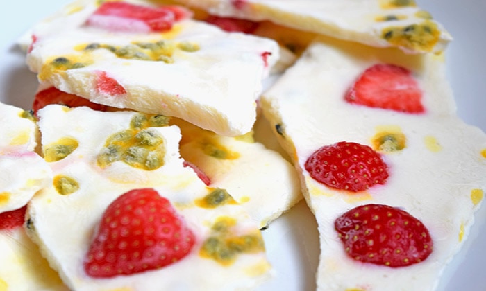 Pieces of lactose-free passionfruit yoghurt bark on a baking sheet