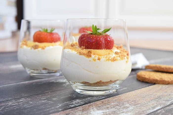 Two glasses of lemon mousse with lemon curd and cookie crumbs
