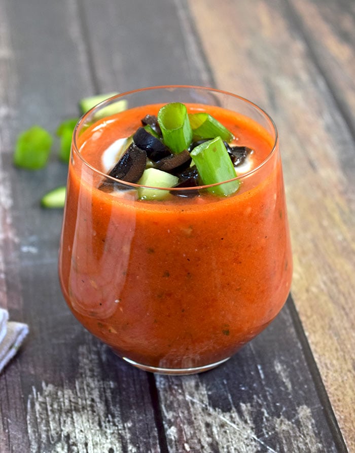 A glass of gazpacho photographed from the side