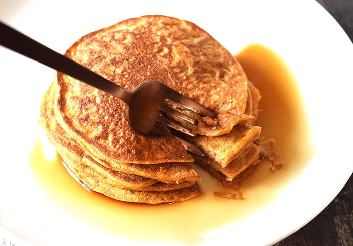A stack of pumpkin pancakes on a plate