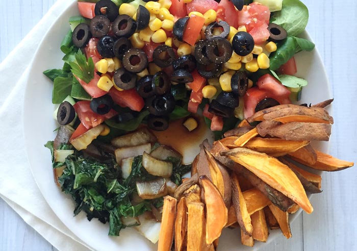 A big salad with sweet potato fries from the oven