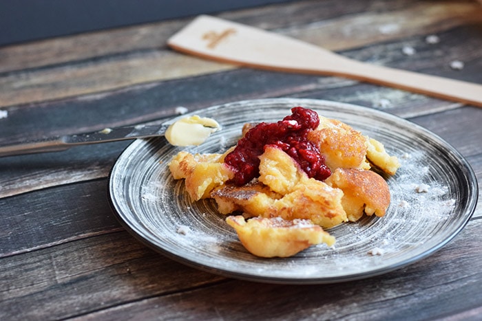 A plate with gluten-free kaiserschmarrn and a spatula behind it
