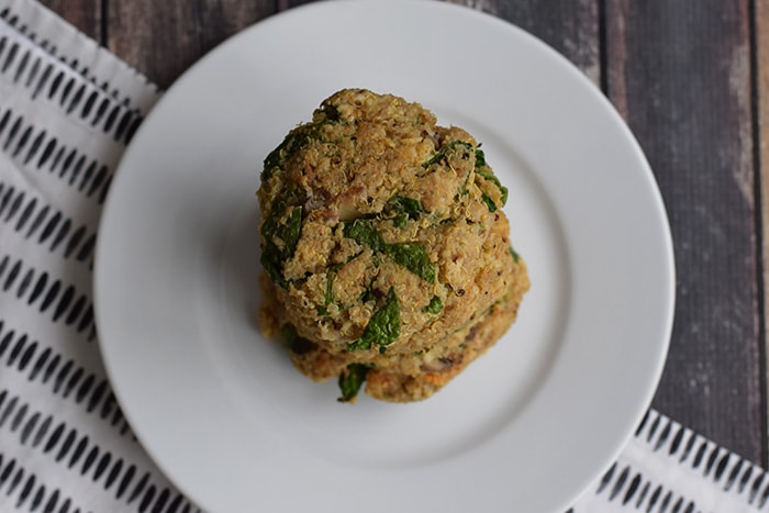 Low FODMAP quinoa burgers with spinach on a plate