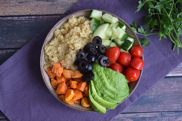 A low FODMAP quinoa bowl with sweet potato photographed from above