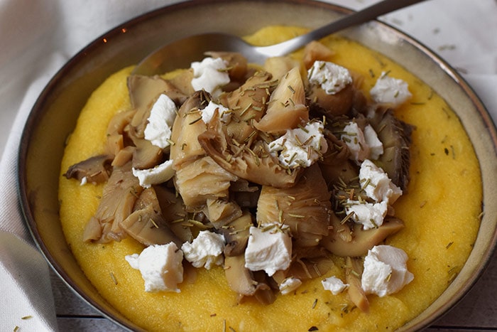 low fodmap mushroom polenta with goat cheese in a bowl