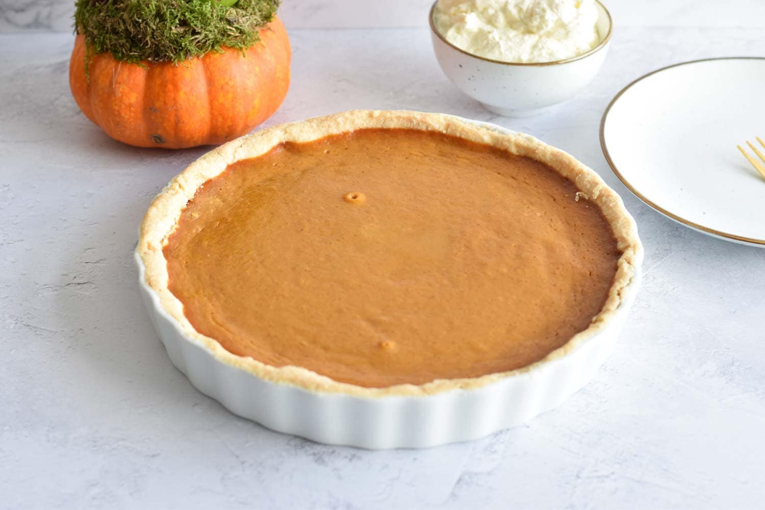 Low FODMAP pumpkin pie with cream on the side