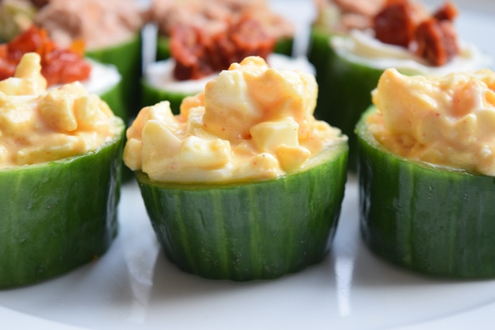 low FODMAP cucumber bites filled with egg salad in a row