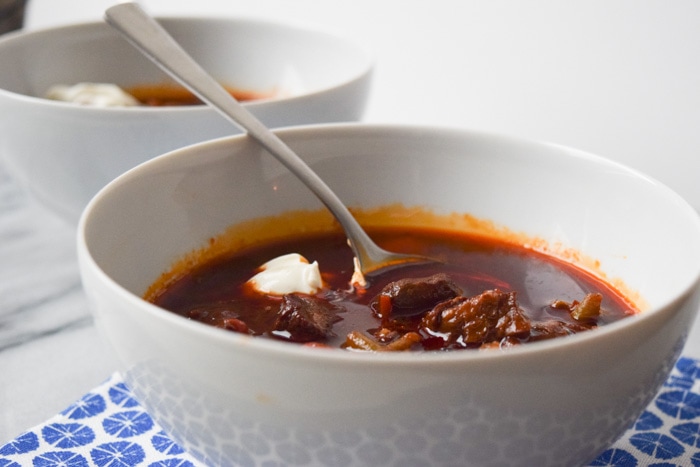 Low FODMAP goulash soup in a bowl photographed from the side