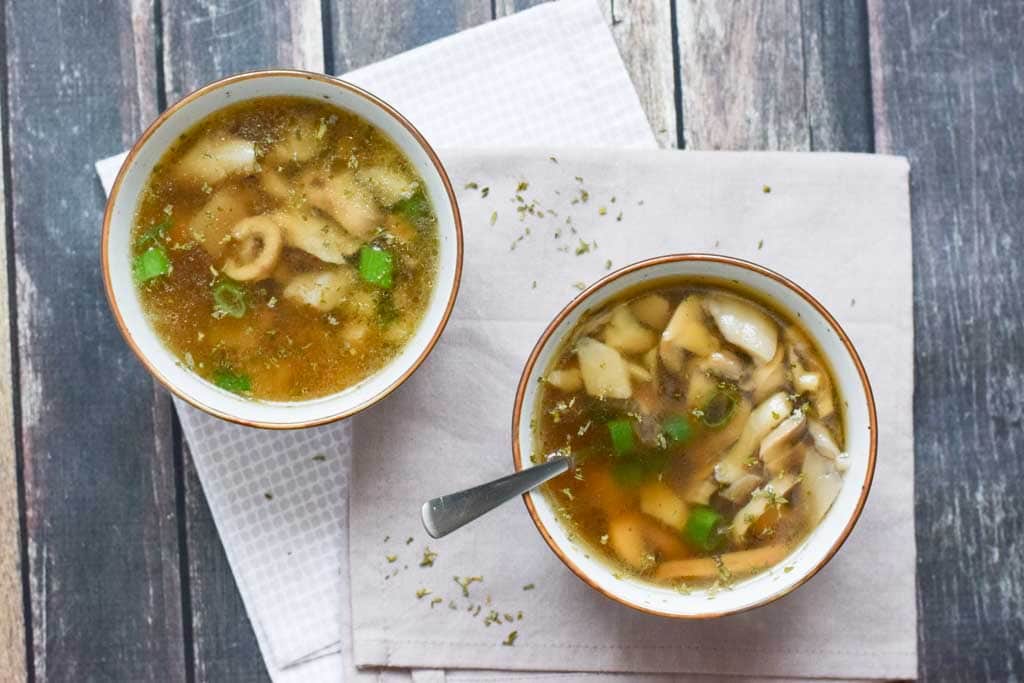Two bowls of low fodmap mushroom soup on a napkin