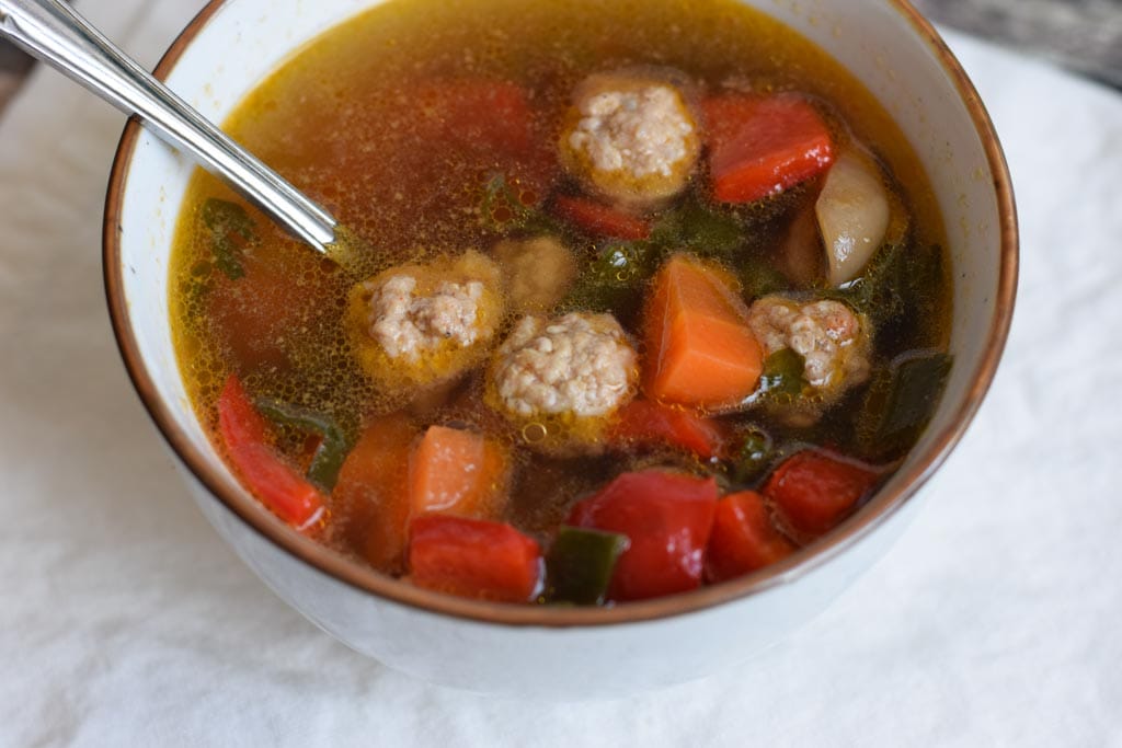 Low FODMAP vegetable soup with meatballs in a bowl