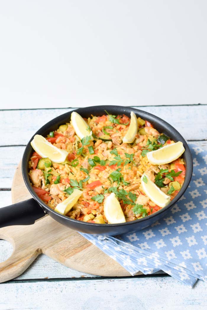 A pan with low FODMAP paella with lemon parts on top