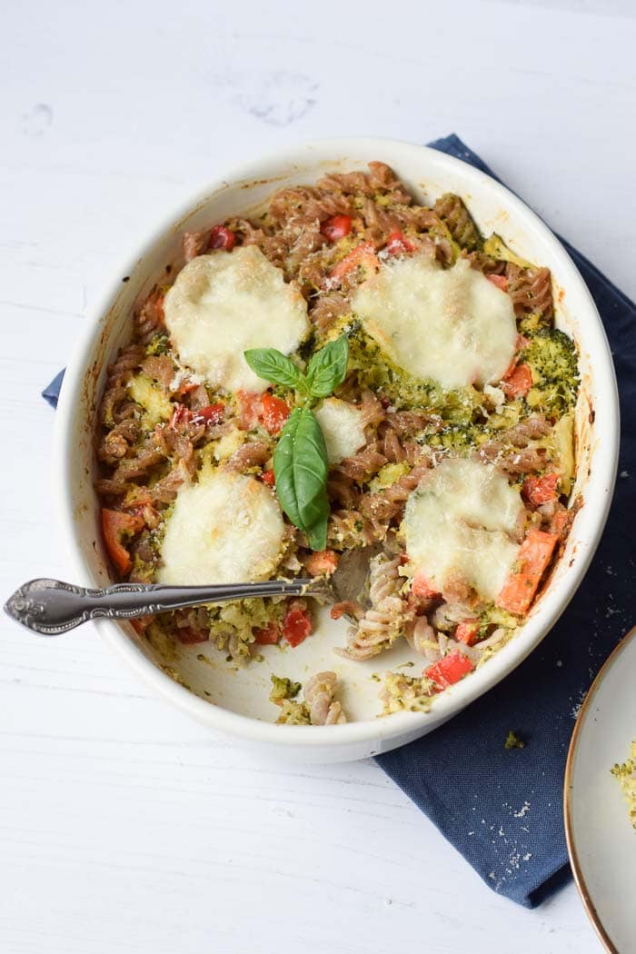 A low FODMAP pasta casserole with pesto with a spoon in it