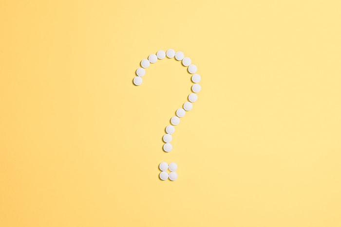 A yellow background with a white question mark