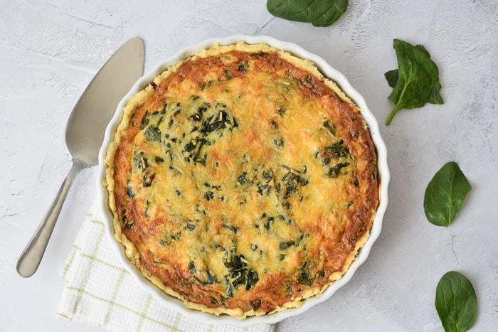A low FODMAP salmon and spinach quiche photographed from above