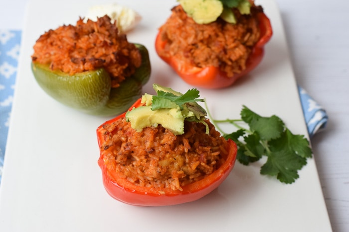 Three half peppers filled with rice, chicken minced meat and cheese. Topped with some avocado and cilantro