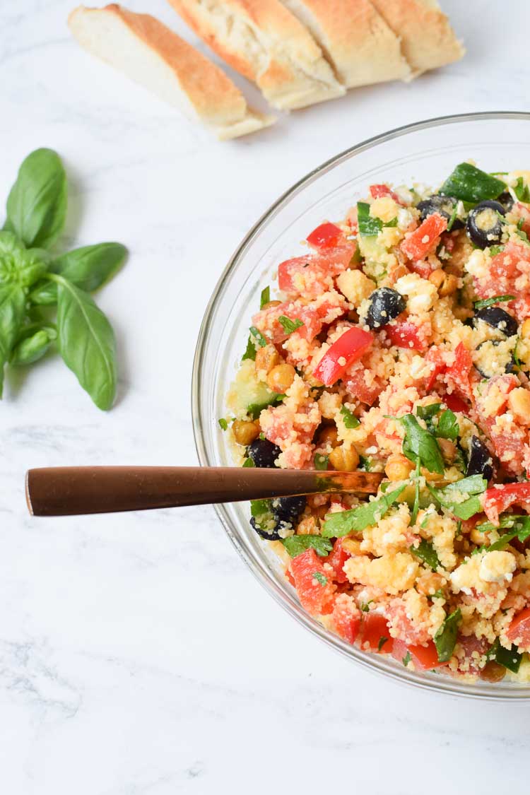 Gluten-free couscous salad in a glass bowl