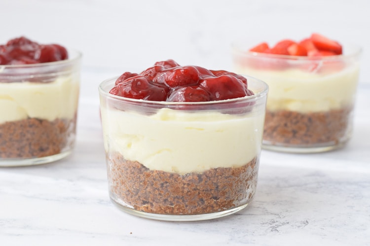 Three glasses with low FODMAP mini strawberry cheesecakes photographed from the side