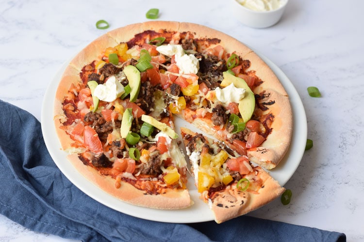 Gluten-free Mexican pizza with one slice out