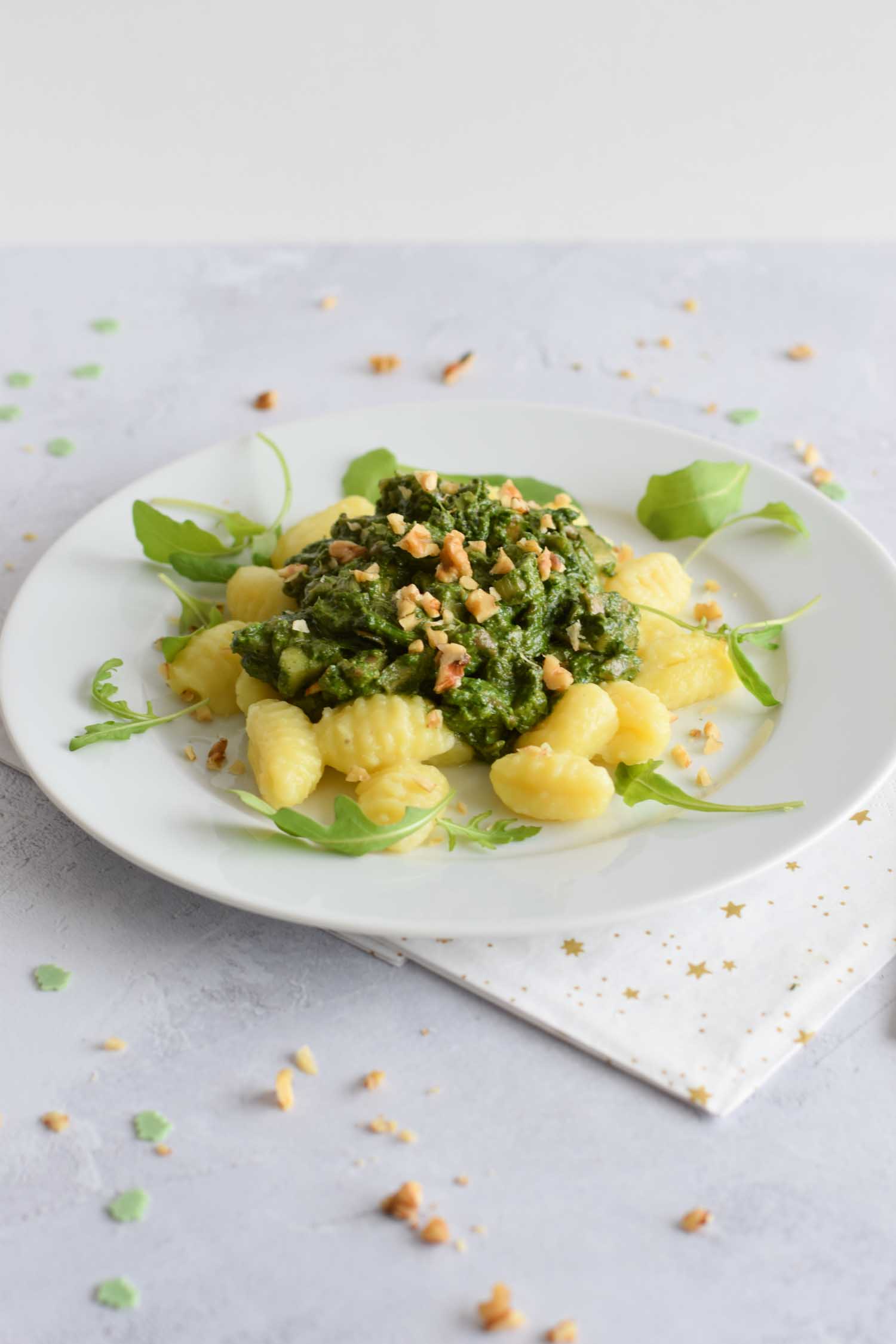 Low FODMAP gnocchi with spinach pesto on a plate