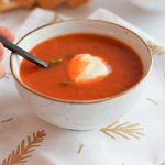 low FODMAP roasted bell pepper soup in a bowl with a spoon in it