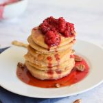 low FODMAP sweet potato pancakes on a plate with raspberries