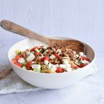Low FODMAP strawberry feta pasta salad in a bowl with a spoon in it