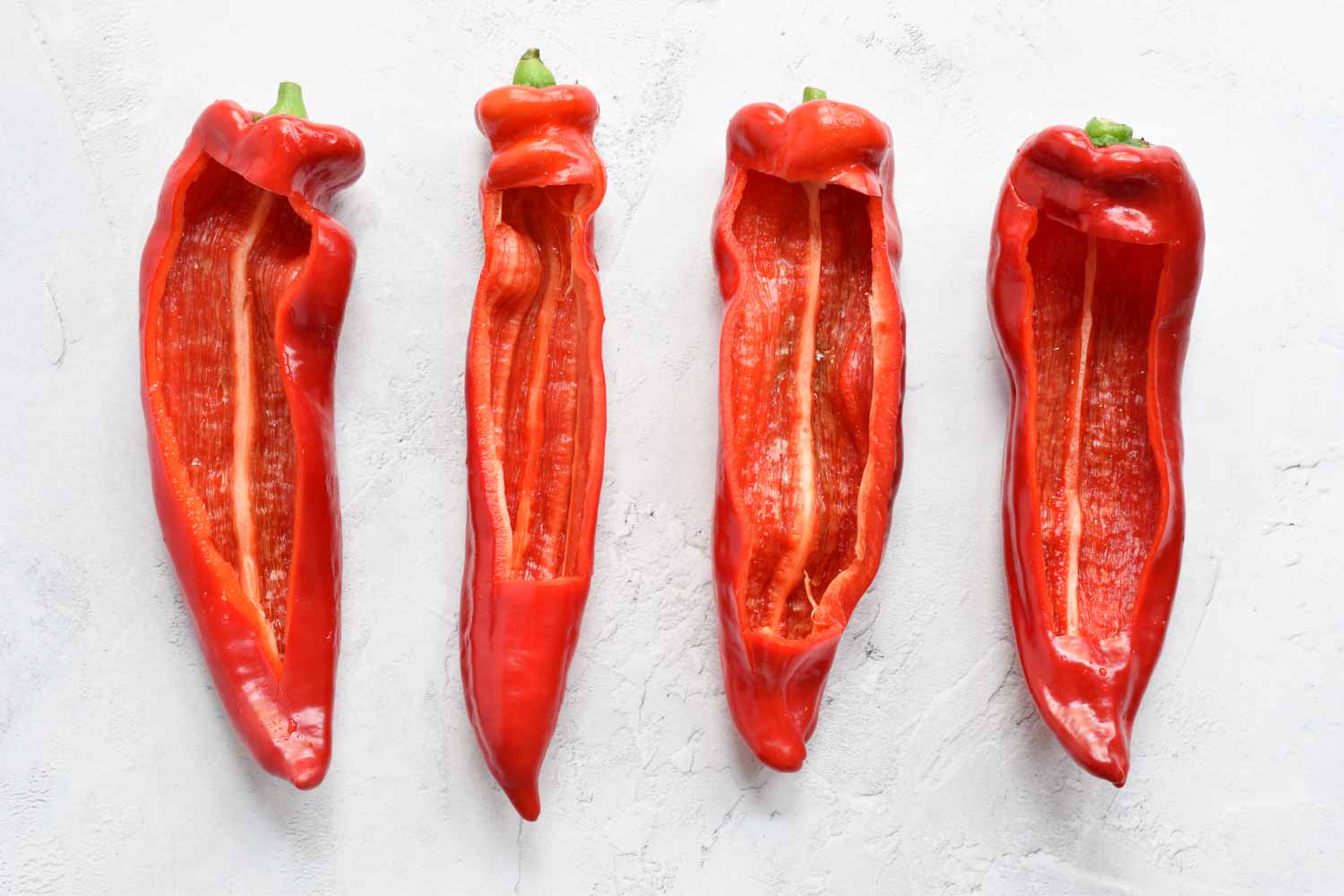 Four cleaned pointed peppers