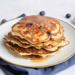 Low FODMAP American pancakes on a plate with maple syrup