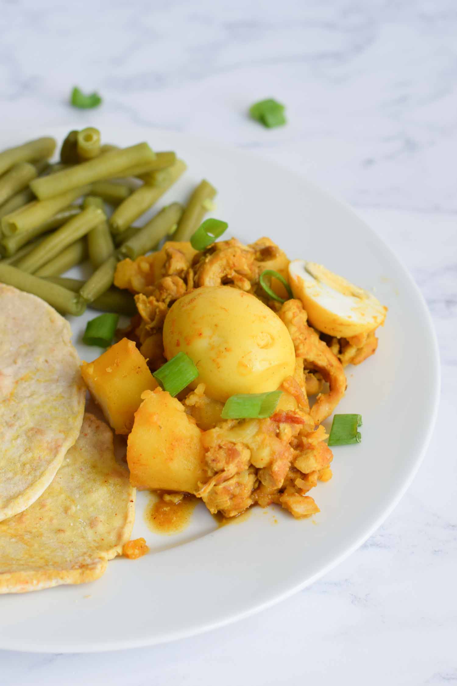 Low FODMAP roti on a plate with green beans