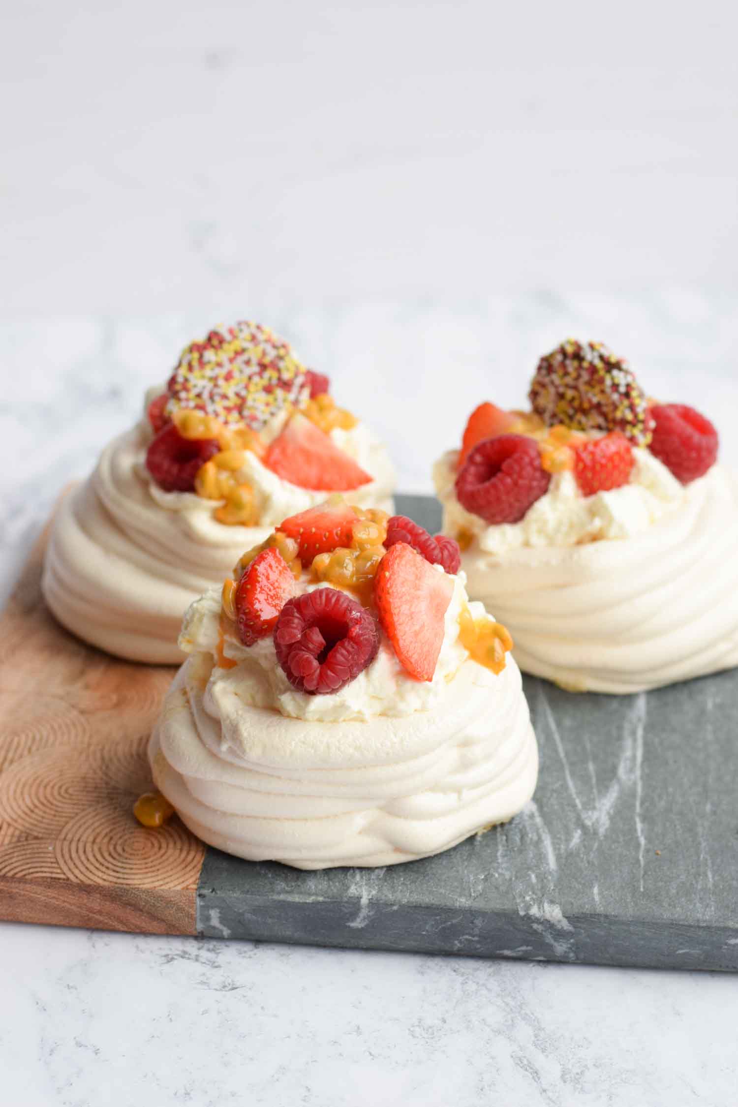 Three low FODMAP mini pavlovas with red fruits and cream