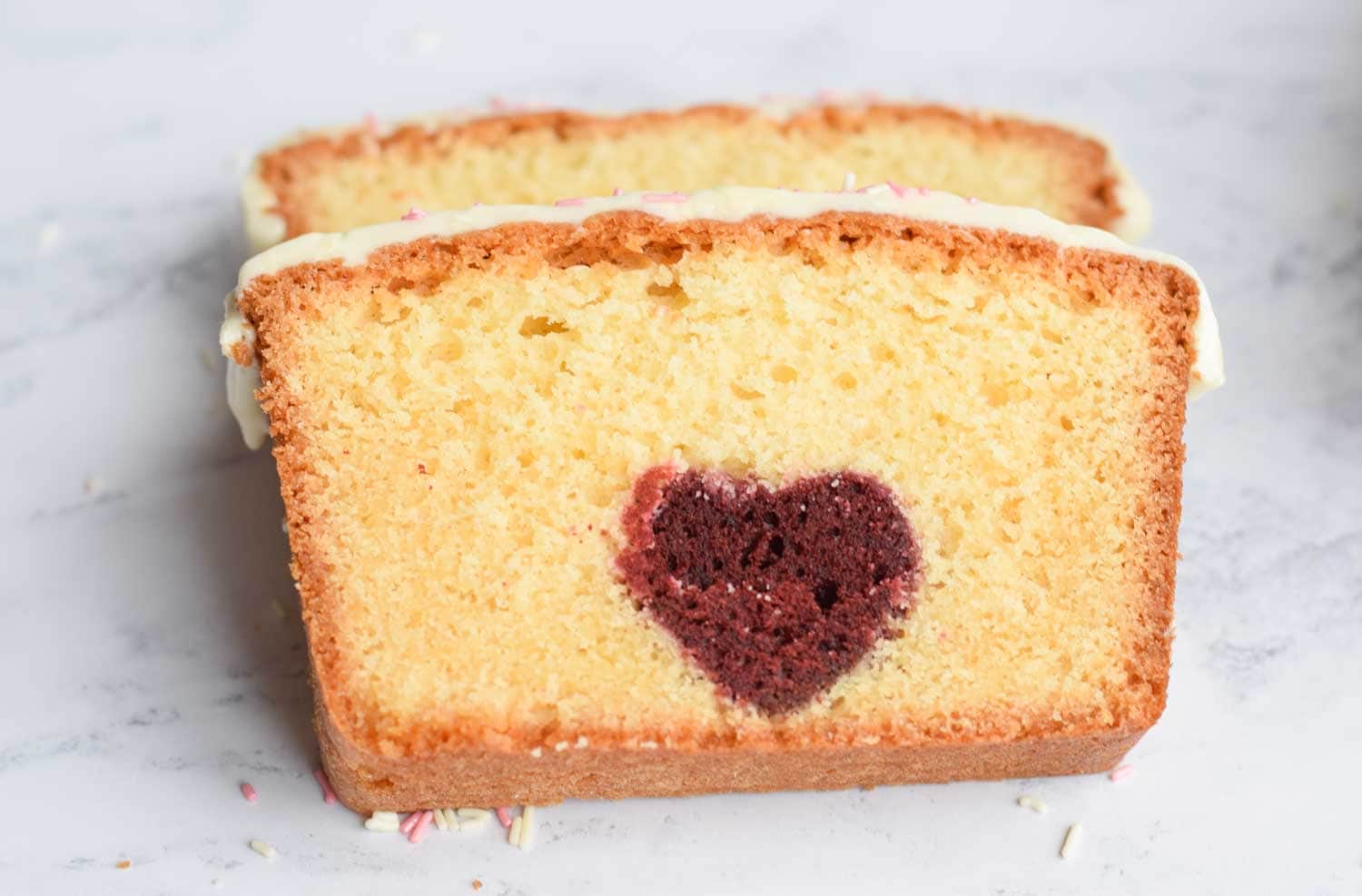 Two slices of gluten-free cake with a heart inside