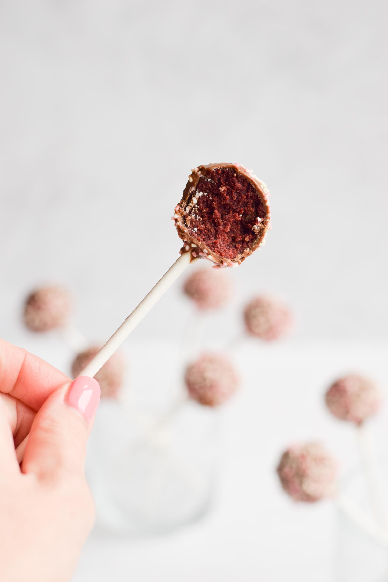 A gluten-free cake pop with a bite out of it