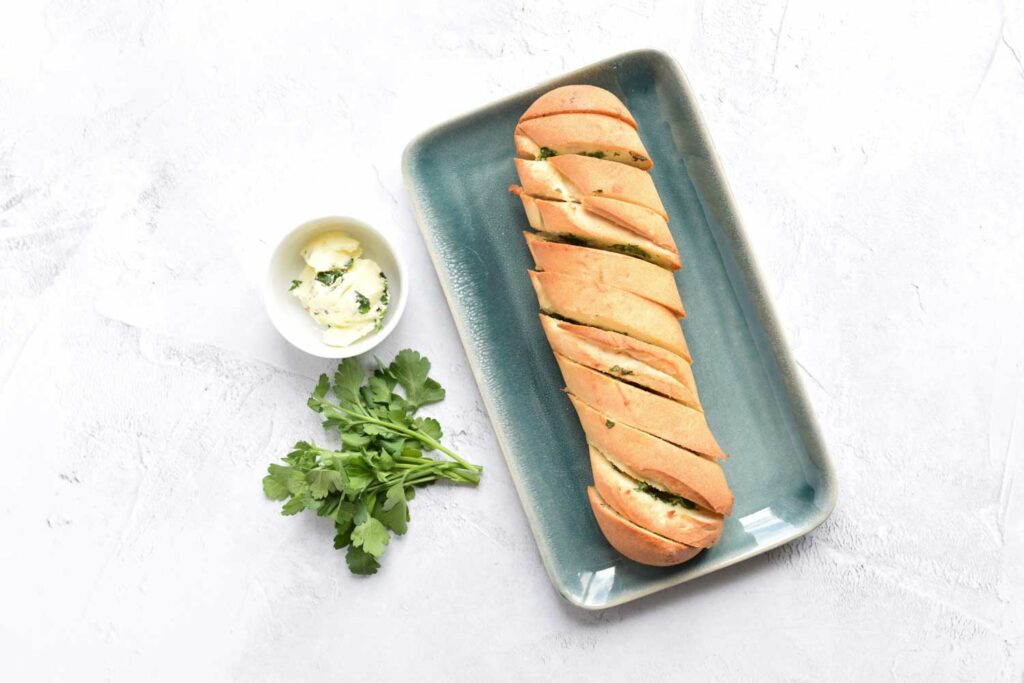 An entire gluten-free baguette with herb butter