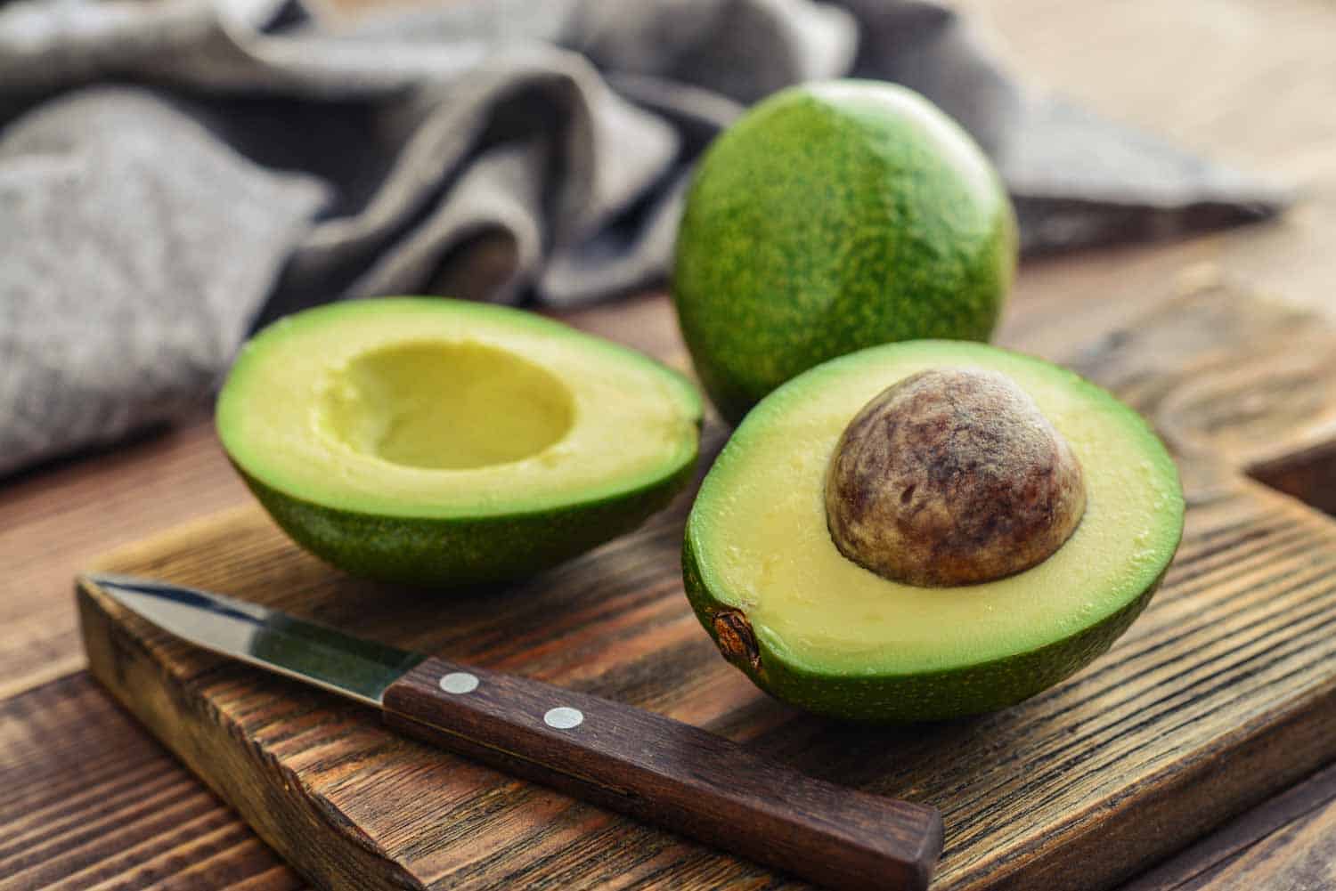 An avocado cut open on a plate
