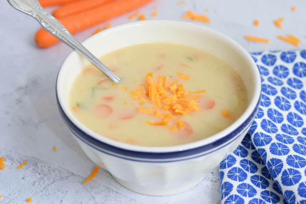A bowl with low FODMAP potato soup with some grated cheddar on top
