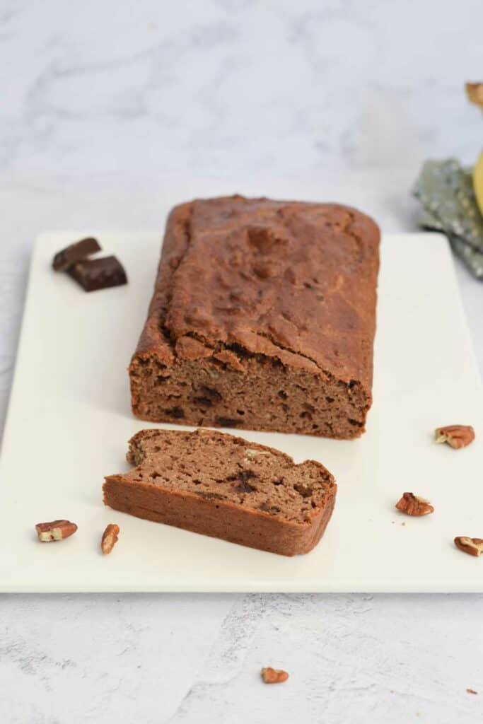 A gluten-free chocolate bananabread with a slice next to it
