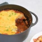 A low FODMAP shepherd's pie in a pan with a plate next to it