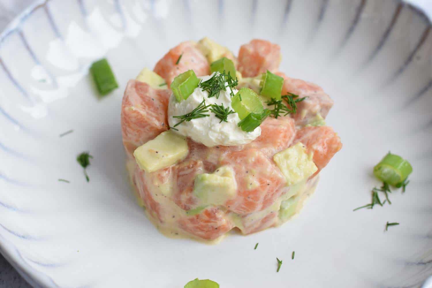 A plate with salmon tartare with avocado