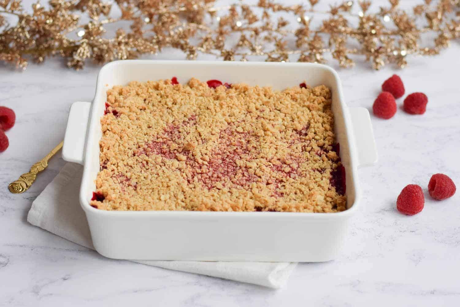 An oven dish with strawberry raspberry crisp