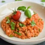 A deep plate with low FODMAP tomato risotto with burrata