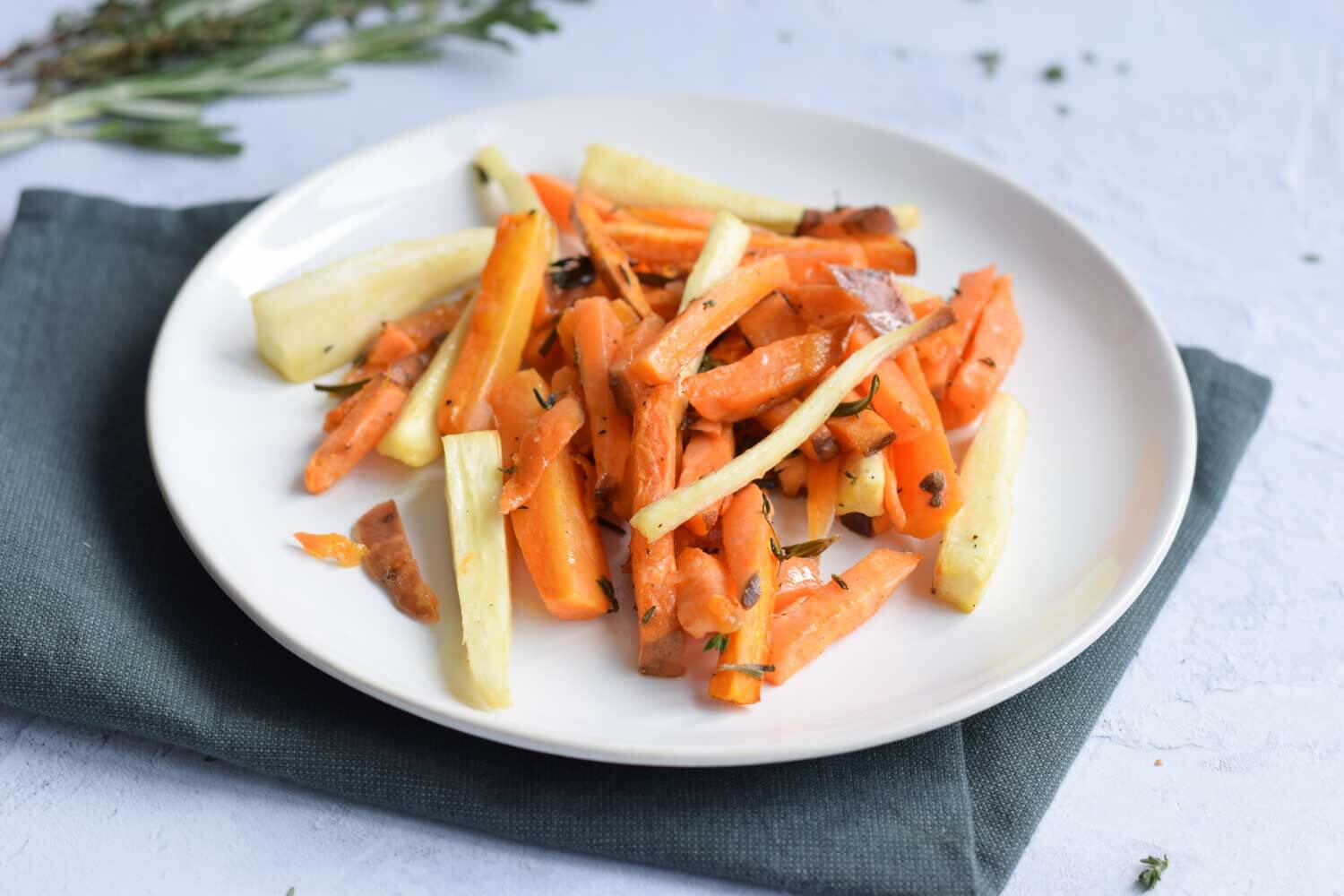 A plate with oven roasted carrots, parsnips and sweet potatoes